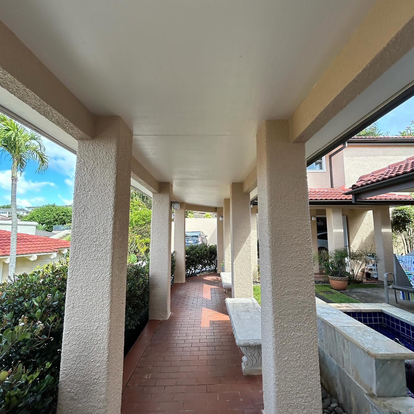 Repainted lanai walkway with stucco columns and fresh ceiling coating on Oahu