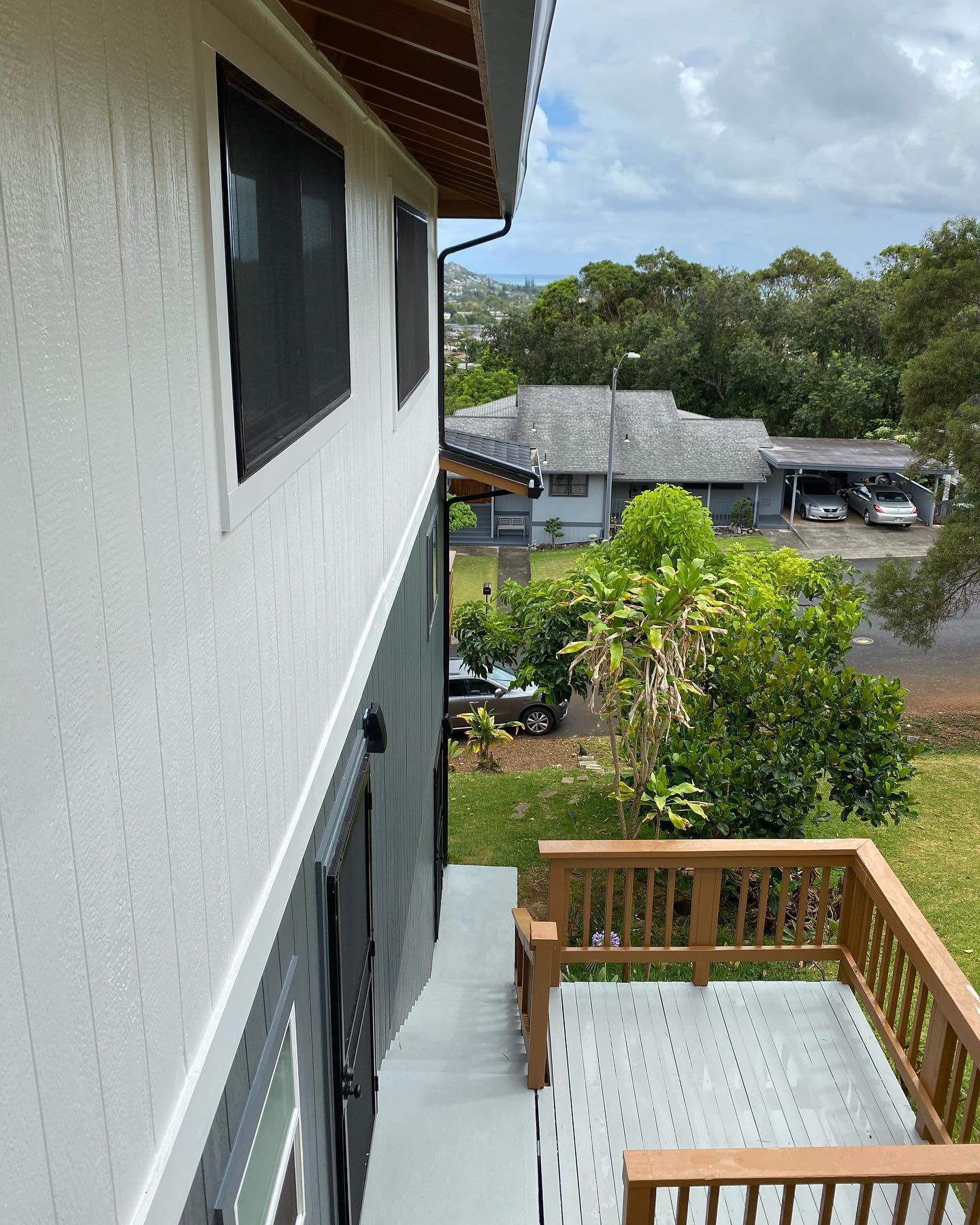 Freshly coated deck and stairs on a hillside Oahu home with town views