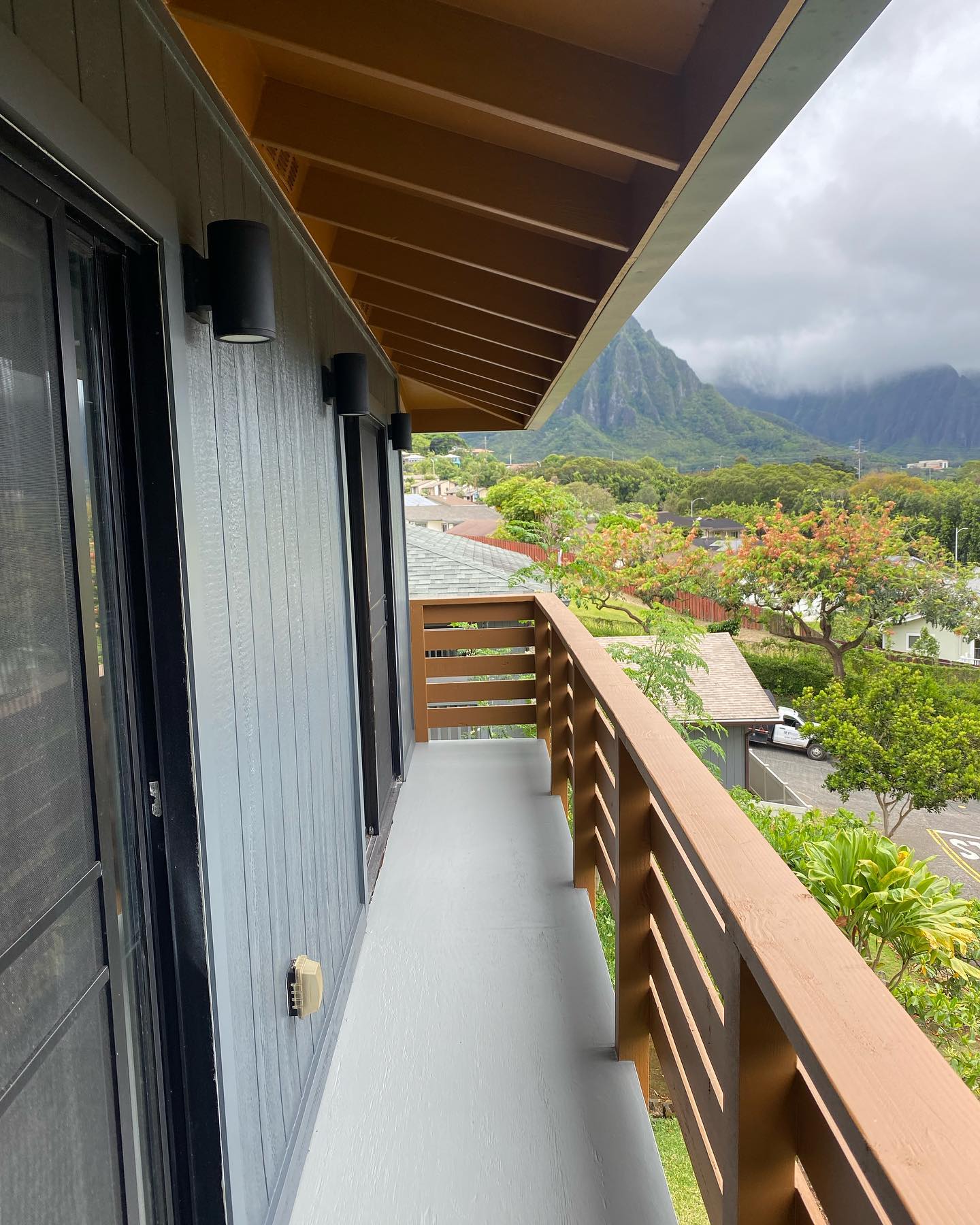 Coated lanai deck with redwood railing and Ko'olau mountain view in Kaneohe