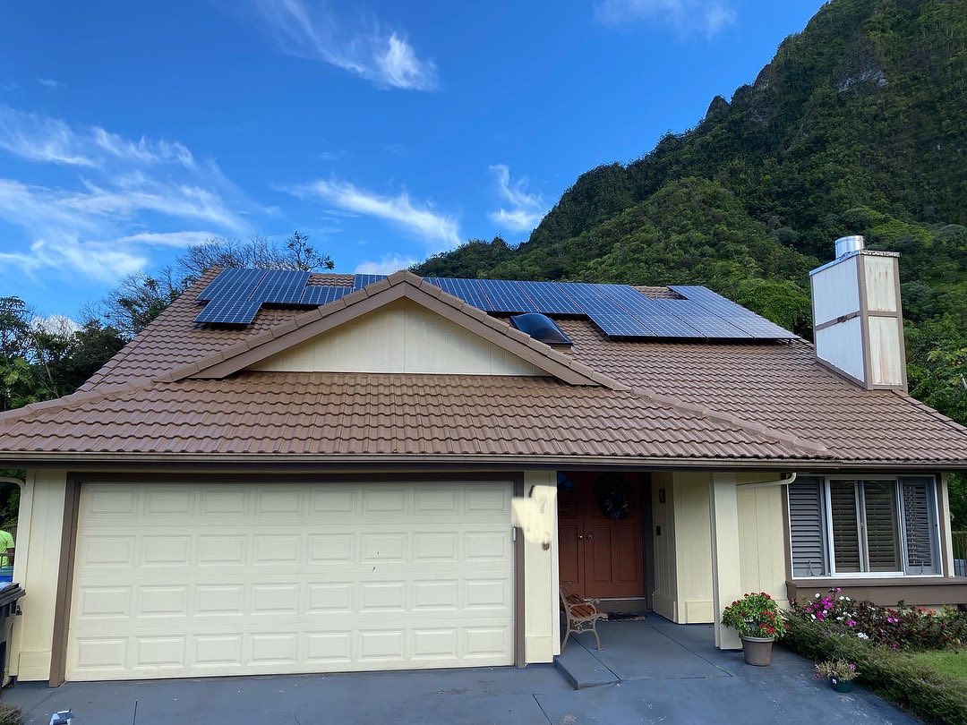 Tile roof home with solar panels and Ko'olau mountain backdrop