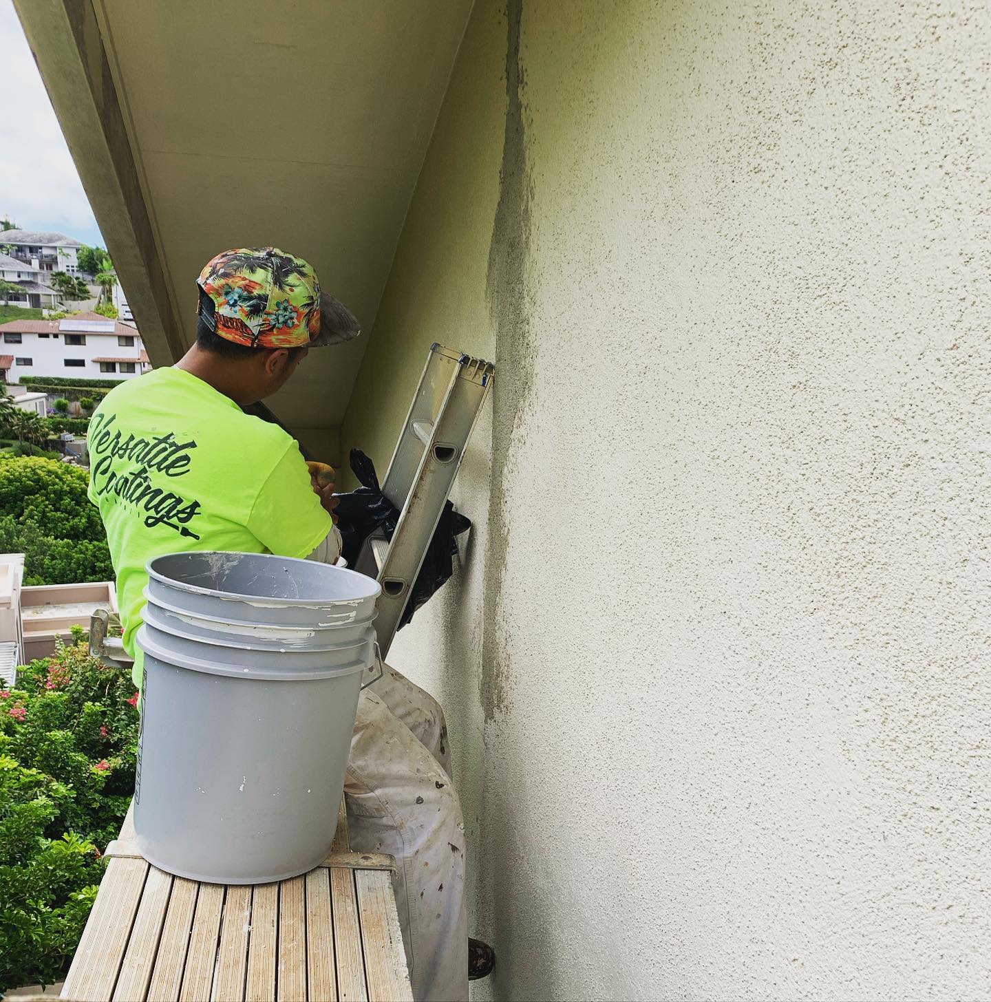 Versatile Coatings crew member prepping a stucco lanai